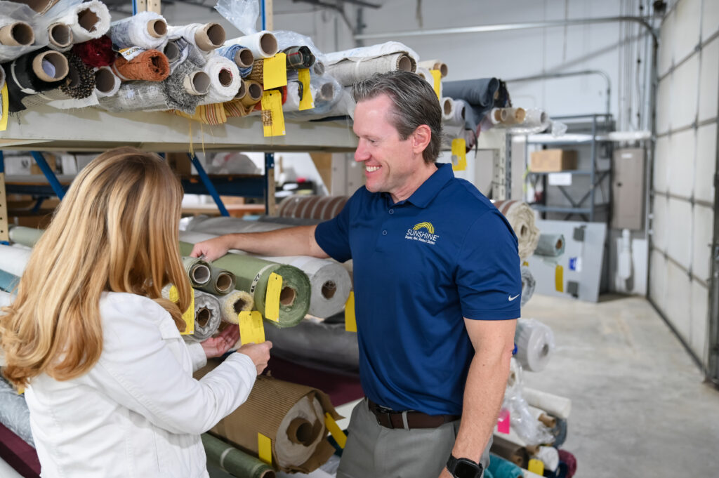 Owner Jason Price of Sunshine Draperies, Blinds, Shades, and Shutters taking inventory with his Wife and Co-owner Taira Price.