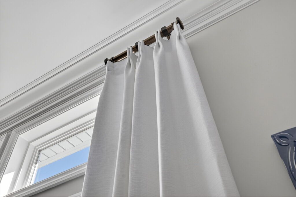 two finger pinch pleat panel on short rods in living room
