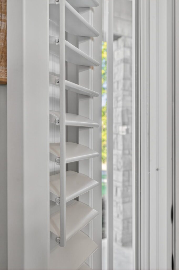 Close up detail of composite white wood shutters with hidden tilt bar